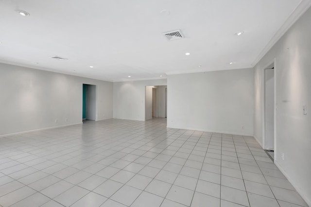 empty room with crown molding and light tile flooring