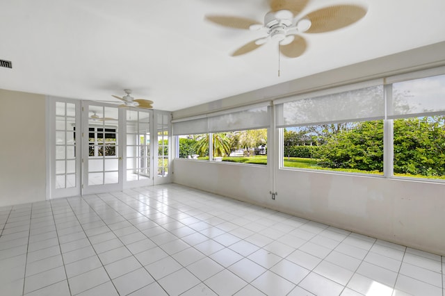 unfurnished sunroom with ceiling fan