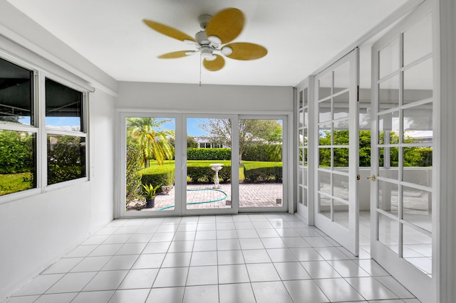 unfurnished sunroom featuring french doors and ceiling fan