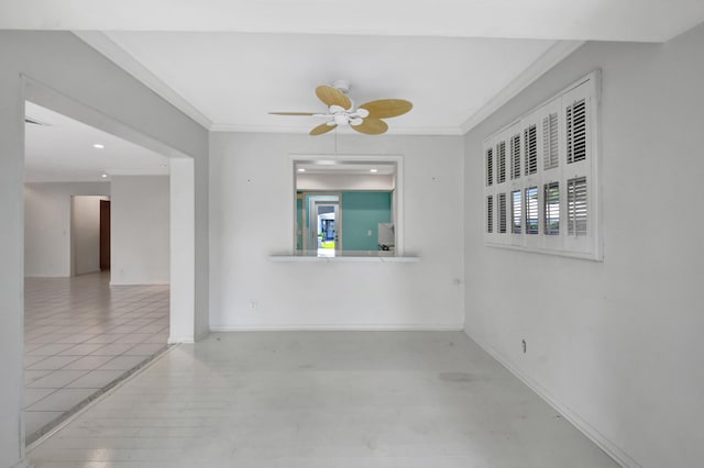 tiled spare room featuring crown molding and ceiling fan