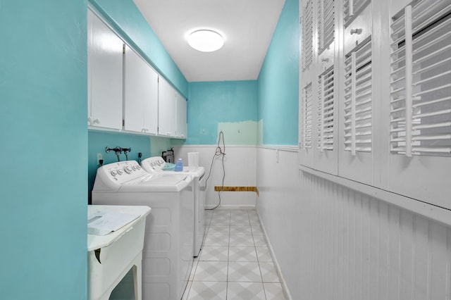 laundry room with washer and dryer, cabinets, light tile floors, radiator, and washer hookup