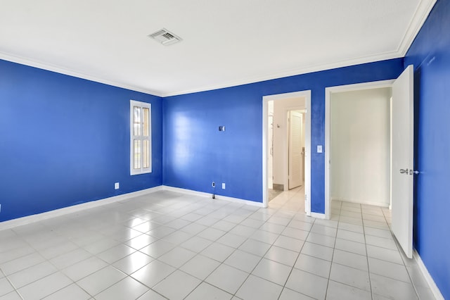 tiled spare room with ornamental molding