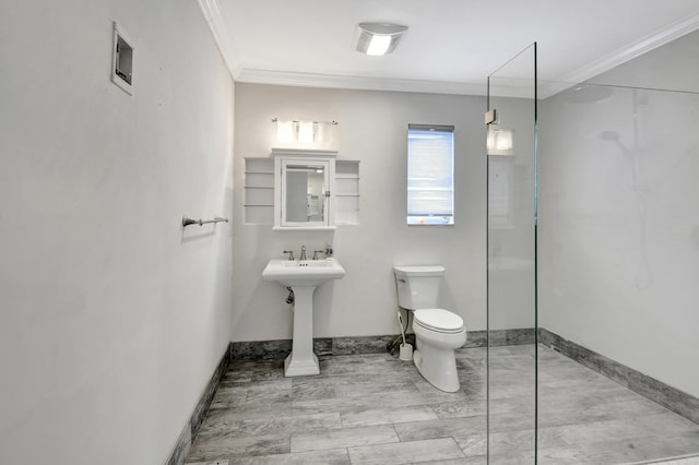 bathroom with ornamental molding, sink, a shower with door, and toilet