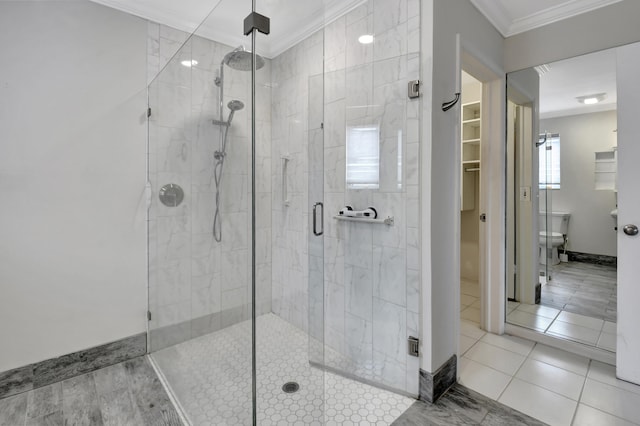 bathroom with tile flooring, ornamental molding, and an enclosed shower