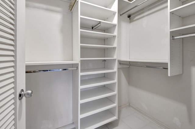 walk in closet featuring tile flooring