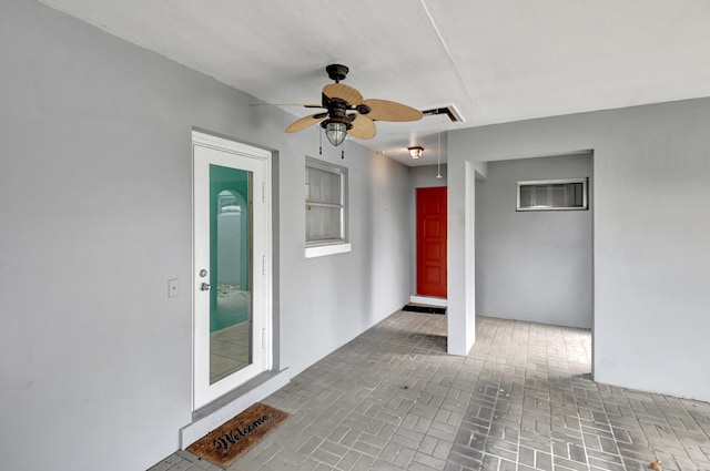 doorway to property with ceiling fan