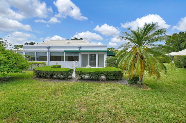 exterior space featuring a yard and a sunroom