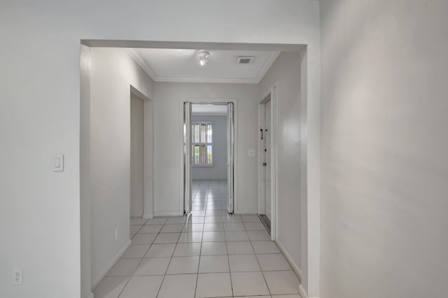 hallway featuring ornamental molding and light tile flooring