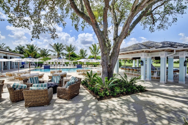 view of patio / terrace with a community pool and a gazebo