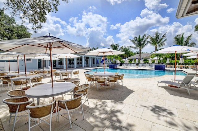 view of pool featuring pool water feature and a patio