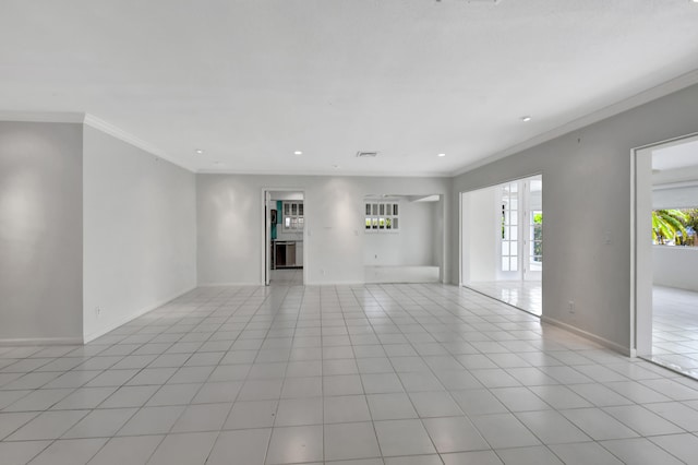 unfurnished living room with crown molding and light tile floors