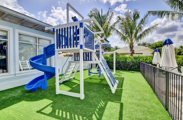 view of playground with a lawn