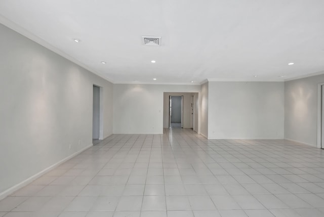 empty room with crown molding and light tile flooring