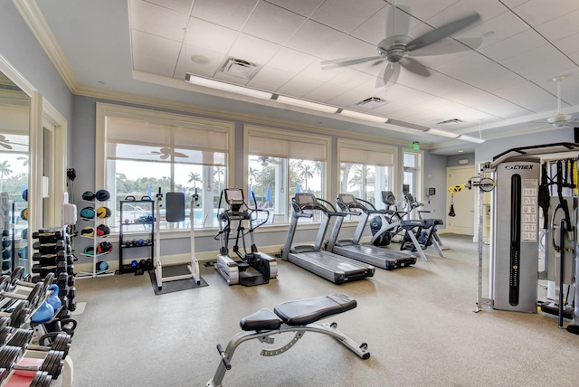 gym featuring ceiling fan, crown molding, and a tray ceiling