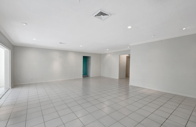 empty room featuring crown molding and light tile flooring