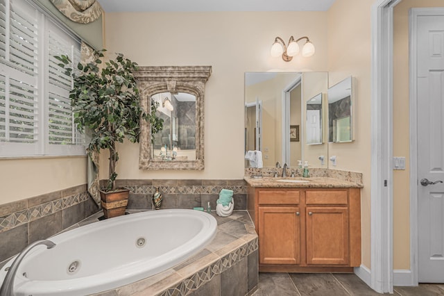 bathroom with vanity and tiled tub