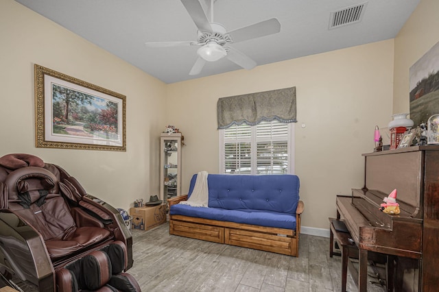 sitting room featuring light wood-type flooring and ceiling fan