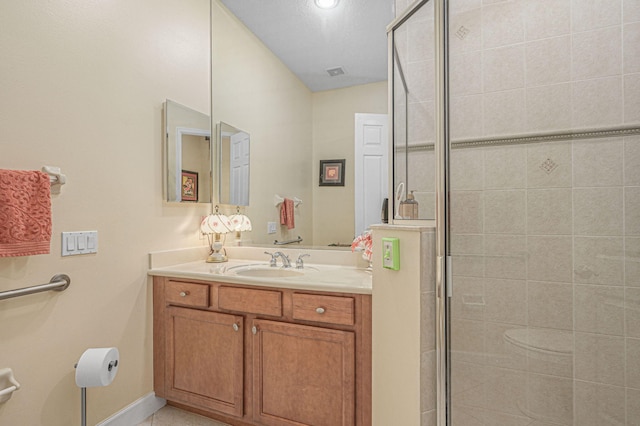 bathroom featuring vanity and an enclosed shower