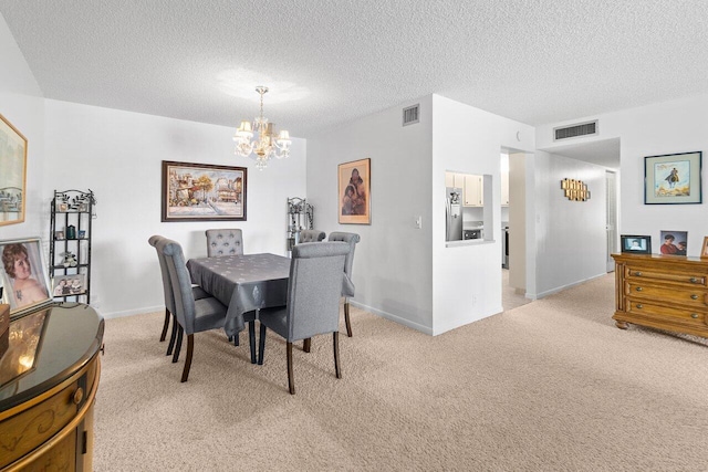 dining space featuring a textured ceiling, light carpet, and a notable chandelier