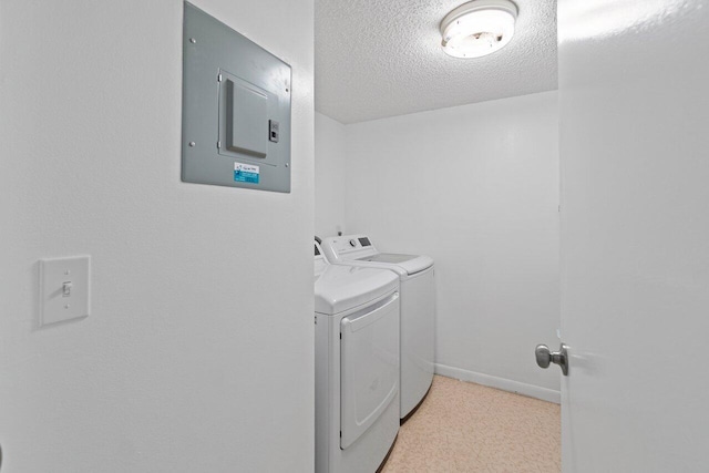 laundry room featuring washer and clothes dryer and a textured ceiling