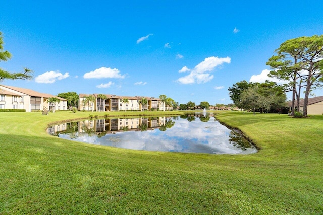 dock area featuring a water view and a lawn