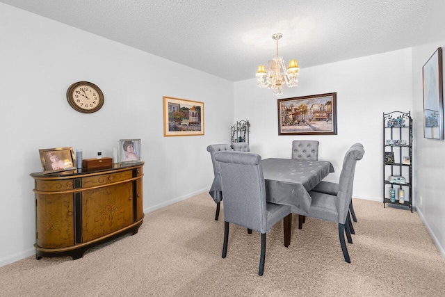 dining area featuring a textured ceiling, carpet floors, and a chandelier