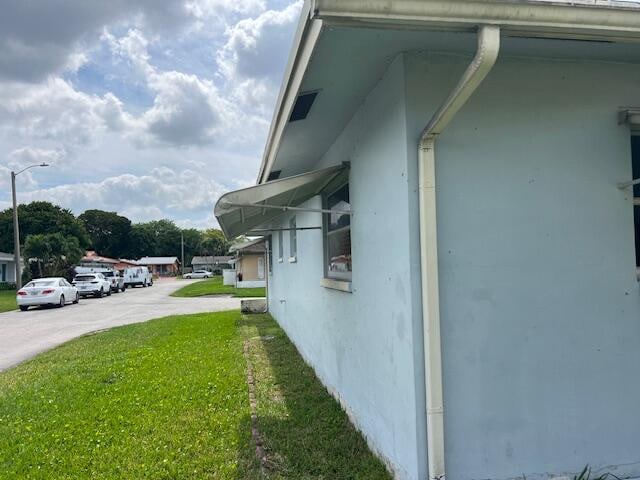 view of side of property with a lawn