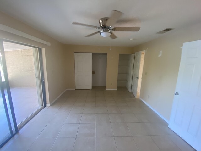 unfurnished bedroom featuring light tile patterned floors and ceiling fan