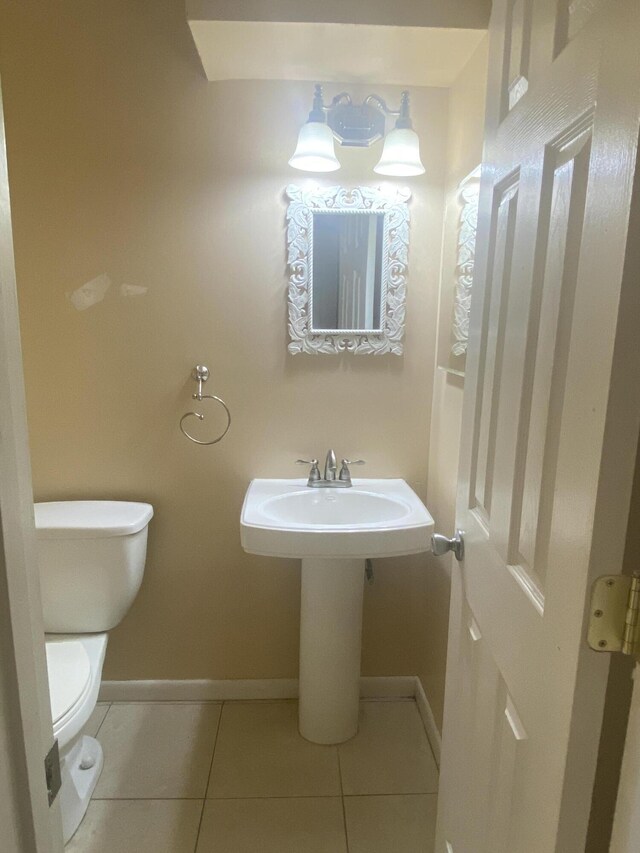 bathroom featuring tile patterned flooring and toilet