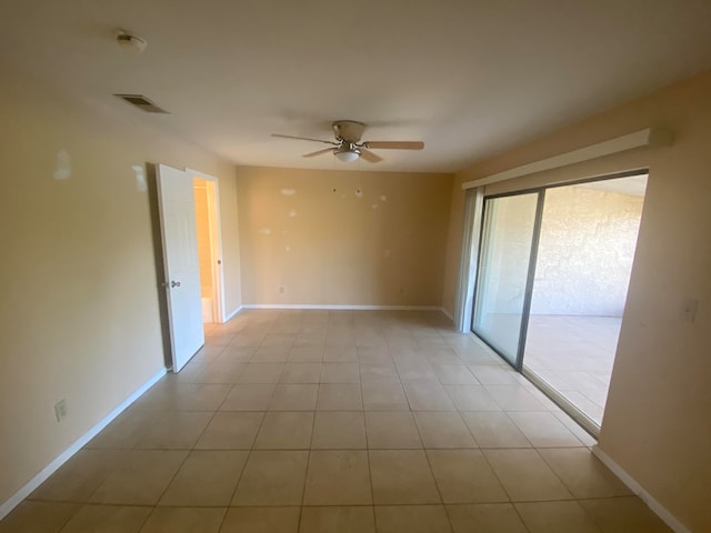 tiled spare room featuring ceiling fan