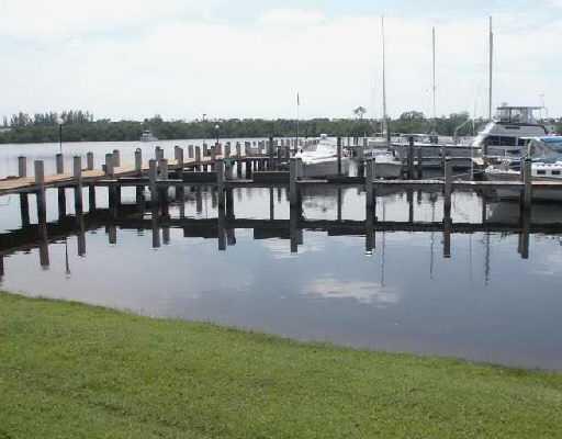 dock area featuring a water view and a lawn