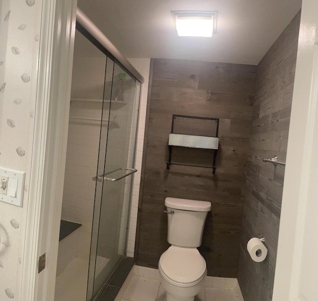 bathroom with tile patterned flooring, a shower stall, and toilet