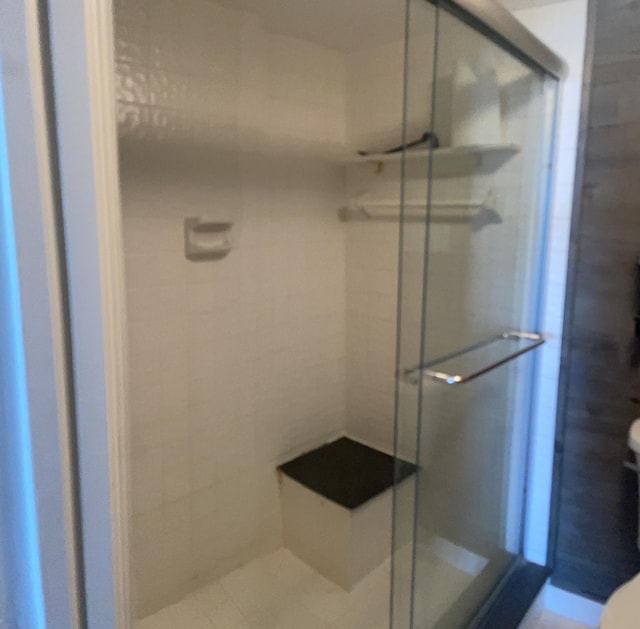 bathroom with a stall shower and toilet