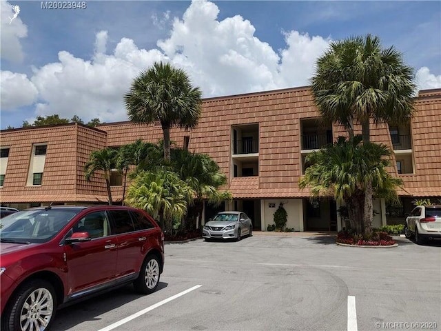 view of building exterior with uncovered parking