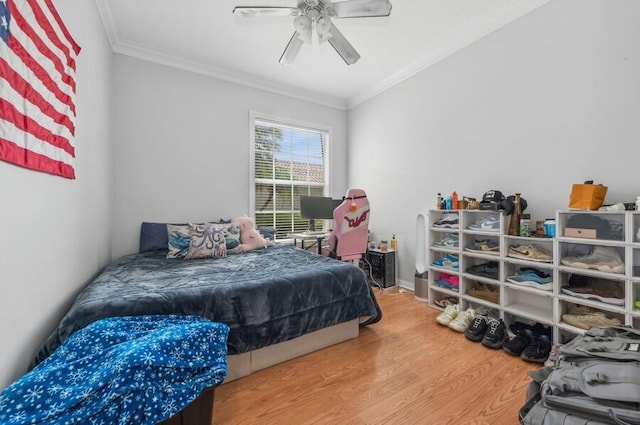 bedroom featuring ceiling fan, hardwood / wood-style flooring, and ornamental molding