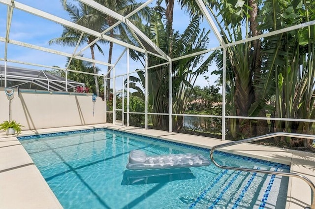 view of pool with a lanai