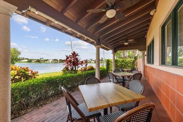 view of terrace featuring a water view and ceiling fan