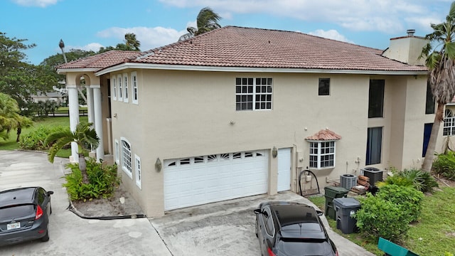 rear view of house with a garage