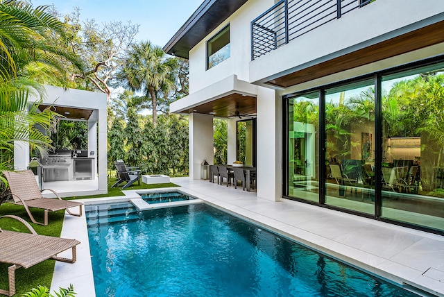 view of pool with ceiling fan, a patio area, and area for grilling