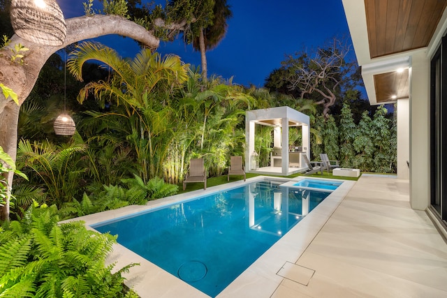 pool at night with a patio