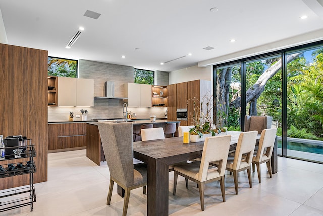 dining area with sink and light tile floors