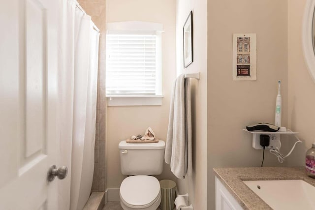 bathroom featuring toilet and vanity