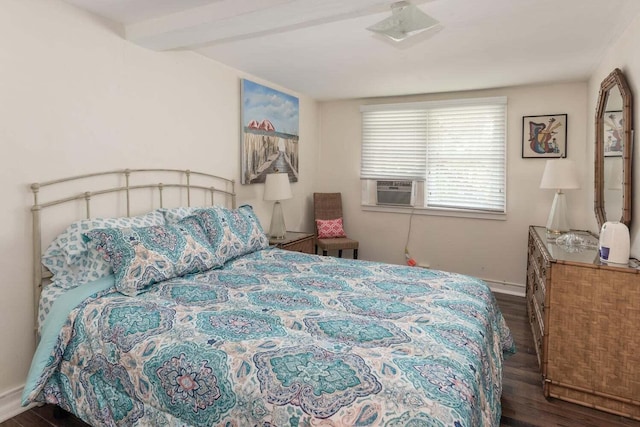 bedroom featuring beamed ceiling and dark hardwood / wood-style flooring