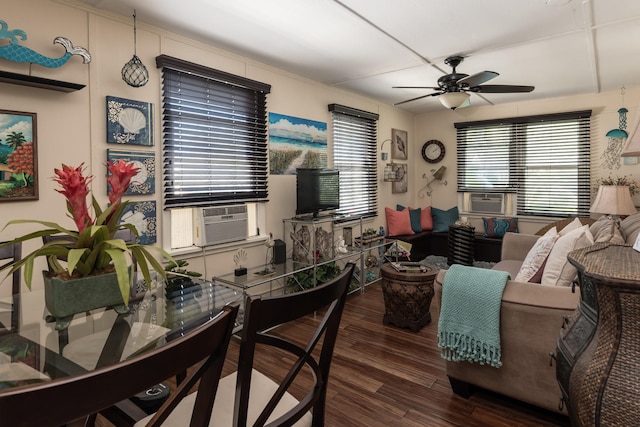 living room with dark hardwood / wood-style flooring, ceiling fan, and a healthy amount of sunlight