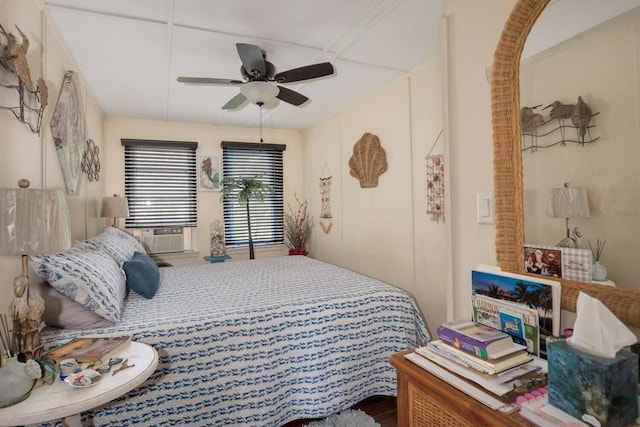 bedroom with ceiling fan and hardwood / wood-style floors