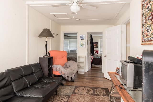 living room featuring ceiling fan and dark wood-type flooring