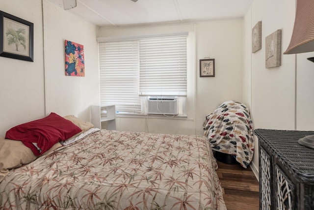 bedroom featuring hardwood / wood-style floors and multiple windows