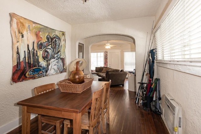 dining room with ceiling fan, dark hardwood / wood-style floors, and a textured ceiling