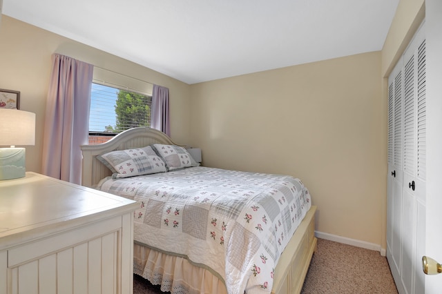 bedroom featuring light colored carpet and a closet