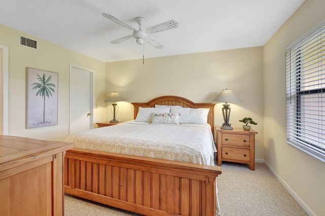 bedroom featuring light carpet, baseboards, and ceiling fan